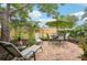 Brick patio with lounge chairs and a table under an umbrella at 430 Beach Park Blvd, Venice, FL 34285