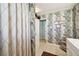 Spa-like bathroom with a walk-in shower and patterned wallpaper at 430 Beach Park Blvd, Venice, FL 34285