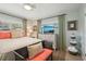 Relaxing bedroom with a comfy bench and a flat-screen TV at 430 Beach Park Blvd, Venice, FL 34285