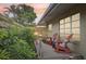 Wooden deck with red rocking chairs and tropical plants at 430 Beach Park Blvd, Venice, FL 34285