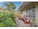 Wooden deck with two red rocking chairs, offering a peaceful retreat at 430 Beach Park Blvd, Venice, FL 34285