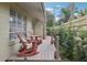 Wooden deck with two red rocking chairs, offering a peaceful retreat at 430 Beach Park Blvd, Venice, FL 34285