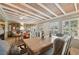 Sunlit dining room features a wood-beamed ceiling and antique furnishings at 430 Beach Park Blvd, Venice, FL 34285