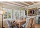 Charming dining room features wood-beamed ceiling and farmhouse table at 430 Beach Park Blvd, Venice, FL 34285