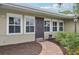 Front door entrance with brick walkway and landscaping at 430 Beach Park Blvd, Venice, FL 34285