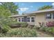 Tan home exterior showcasing lush landscaping and palm trees at 430 Beach Park Blvd, Venice, FL 34285