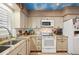 Well-equipped kitchen with granite countertops and white cabinets at 430 Beach Park Blvd, Venice, FL 34285