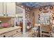 Kitchen features granite countertops, custom cabinetry, and a charming painted ceiling at 430 Beach Park Blvd, Venice, FL 34285