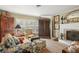 Living room with fireplace, comfy seating, and large windows at 430 Beach Park Blvd, Venice, FL 34285