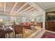 Spacious living room with wood-beamed ceiling, antique furniture, and lots of natural light at 430 Beach Park Blvd, Venice, FL 34285