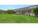 Landscaped backyard with large grassy area and screened patio at 4810 Sparkling Sea Ln, Bradenton, FL 34211
