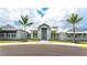Exterior of community clubhouse with palm trees and landscaping at 4810 Sparkling Sea Ln, Bradenton, FL 34211