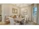 Elegant dining room with wood table, neutral decor, and ample natural light at 4810 Sparkling Sea Ln, Bradenton, FL 34211