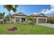 Landscaped one-story home with palm trees and two-car garage at 4810 Sparkling Sea Ln, Bradenton, FL 34211