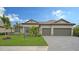 One-story home with tile roof, two-car garage, and landscaped yard at 4810 Sparkling Sea Ln, Bradenton, FL 34211
