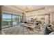 Open concept living room with kitchen view, and access to a relaxing outdoor area at 4810 Sparkling Sea Ln, Bradenton, FL 34211