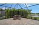 Screened patio with table and chairs overlooking lake at 4810 Sparkling Sea Ln, Bradenton, FL 34211