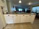 Kitchen island with granite countertop and white cabinets at 4869 Independence Dr # 4869, Bradenton, FL 34210