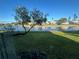 Scenic view of a tranquil lake, lush green grass, and charming homes at 4869 Independence Dr # 4869, Bradenton, FL 34210