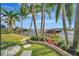 Landscaped backyard with walkway, lush greenery, and waterfront access at 5125 Tidewater Preserve Blvd, Bradenton, FL 34208
