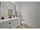 Bathroom with white vanity, black accents, and a toilet at 5125 Tidewater Preserve Blvd, Bradenton, FL 34208