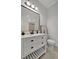 Bathroom with white vanity, black accents, and a toilet at 5125 Tidewater Preserve Blvd, Bradenton, FL 34208