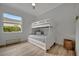 Bedroom with bunk beds and light wood floors at 5125 Tidewater Preserve Blvd, Bradenton, FL 34208