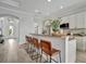 Open kitchen features a large island with seating and views to entryway at 5125 Tidewater Preserve Blvd, Bradenton, FL 34208