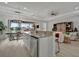 Kitchen island with seating overlooks living room and water views at 5125 Tidewater Preserve Blvd, Bradenton, FL 34208