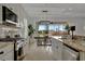 Bright kitchen with granite countertops, stainless steel appliances, and view to backyard at 5125 Tidewater Preserve Blvd, Bradenton, FL 34208