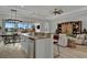 Kitchen island with seating overlooks living room and water views at 5125 Tidewater Preserve Blvd, Bradenton, FL 34208