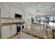 Granite countertops and white shaker cabinets in this kitchen at 5125 Tidewater Preserve Blvd, Bradenton, FL 34208