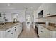 Modern kitchen with granite countertops, stainless steel appliances, and white cabinets at 5125 Tidewater Preserve Blvd, Bradenton, FL 34208