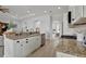 Modern kitchen with granite countertops, stainless steel appliances, and white cabinets at 5125 Tidewater Preserve Blvd, Bradenton, FL 34208