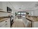 Open kitchen with stainless steel appliances and granite countertops at 5125 Tidewater Preserve Blvd, Bradenton, FL 34208