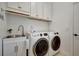 Laundry room with white cabinets, sink, washer and dryer at 5125 Tidewater Preserve Blvd, Bradenton, FL 34208