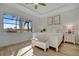 Spacious main bedroom with large window, ceiling fan and white furniture at 5125 Tidewater Preserve Blvd, Bradenton, FL 34208