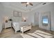 Spacious main bedroom with large window, ceiling fan and white furniture at 5125 Tidewater Preserve Blvd, Bradenton, FL 34208