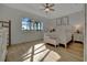 Spacious main bedroom with large window, ceiling fan and white furniture at 5125 Tidewater Preserve Blvd, Bradenton, FL 34208