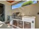 Stainless steel outdoor kitchen with grill, sink, and mini-fridge at 5125 Tidewater Preserve Blvd, Bradenton, FL 34208