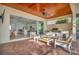 Covered patio with seating area and view into the home at 5125 Tidewater Preserve Blvd, Bradenton, FL 34208