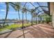 Relaxing screened patio overlooking the water with brick pavers and wicker furniture at 5125 Tidewater Preserve Blvd, Bradenton, FL 34208