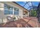 Relaxing screened patio with wicker chairs and water view at 5125 Tidewater Preserve Blvd, Bradenton, FL 34208