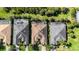 High-angle view of three homes with dark-colored roofs and screened-in patios at 5203 Lake Overlook Ave, Bradenton, FL 34208