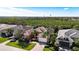 Aerial view of three homes with tile roofs and lush landscaping at 5203 Lake Overlook Ave, Bradenton, FL 34208
