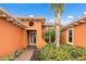 Single-Gathering home with orange exterior and walkway at 5203 Lake Overlook Ave, Bradenton, FL 34208