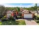 Single-Gathering home with orange exterior and tile roof at 5203 Lake Overlook Ave, Bradenton, FL 34208