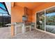 Outdoor kitchen with stainless steel appliances and granite countertops at 5203 Lake Overlook Ave, Bradenton, FL 34208