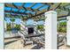 Outdoor kitchen with pergola, grill, and fireplace at 5203 Lake Overlook Ave, Bradenton, FL 34208