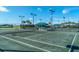 Well-lit tennis courts with covered seating areas at 5203 Lake Overlook Ave, Bradenton, FL 34208